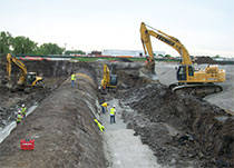 Crews excavate around city sewer line.