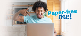 excited man using laptop for paper free billing