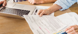 elderly couple paying bills