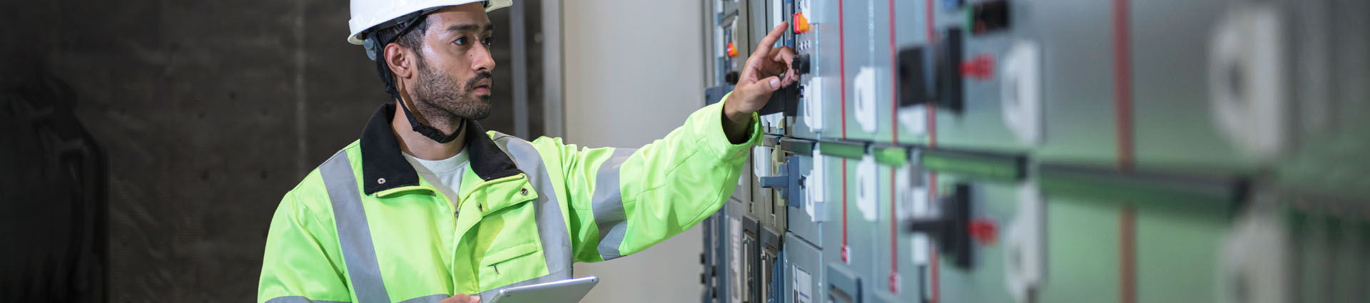 worker checking gauges on the wall